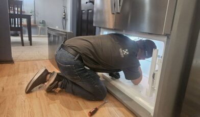 Freezer not freezing — Wilson & Myers technician inspecting freezer evaporator panel in Denver Metro Area home