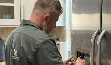 LG refrigerator ice maker not working — Wilson and Myers technician inspecting LG French Door freezer compartment in Denver Metro Area home