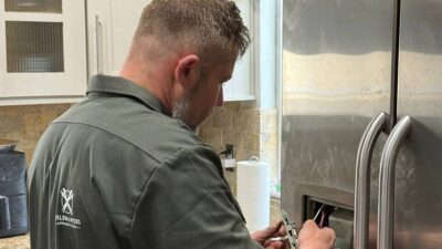 LG refrigerator ice maker not working — Wilson and Myers technician inspecting LG French Door freezer compartment in Denver Metro Area home