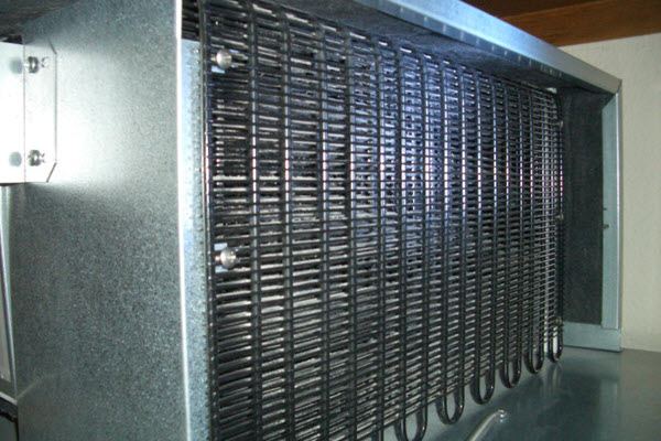 Sub-Zero refrigerator caged condenser unit located behind front grille typically seen on 685 and 695 models for vacuuming and cleaning maintenance