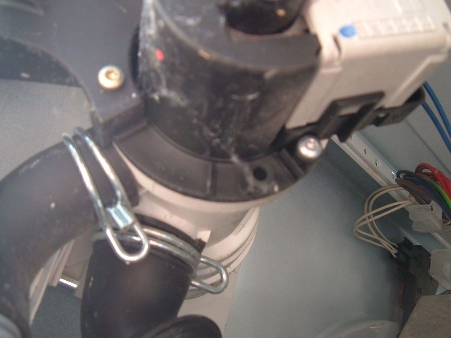 Washing machine drain pump motor assembly showing electrical connections; failed pump prevents washer from draining