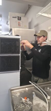 Technician checking the ice bin during a service call