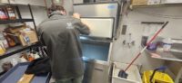Technician servicing a commercial ice machine in Denver Metro