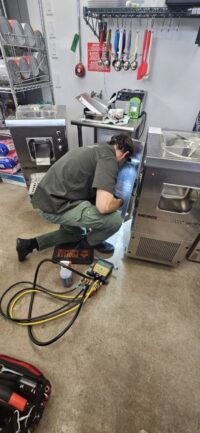 Technician working on a commercial cooler in Denver Metro