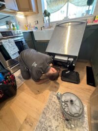 Drain pump removed during a dishwasher repair