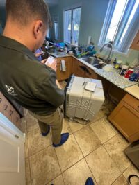 Technician diagnosing a dishwasher that will not start