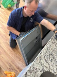 Dishwasher door panel removed to reach the vent and seal