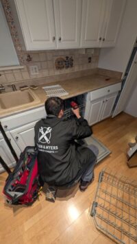 Technician servicing a built in dishwasher in Denver Metro
