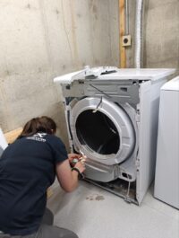 Technician checking dryer controls during a no start call