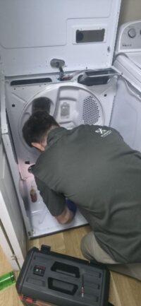 Technician diagnosing a dryer that will not start