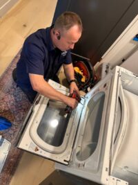 Technician checking the control area of a laundry pair