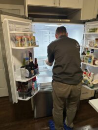 Technician inspecting a freezer that stopped holding temperature