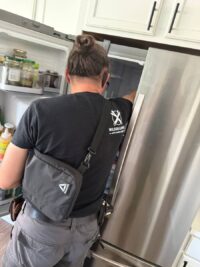 Technician explaining freezer repair options in Denver Metro