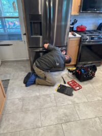 Technician preparing for a freezer repair in a Denver home