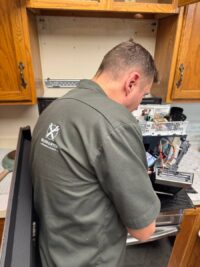 Technician diagnosing a built in microwave in Denver Metro
