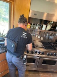 Technician evaluating a professional style range