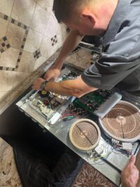 Electric cooktop elements exposed during a heating repair