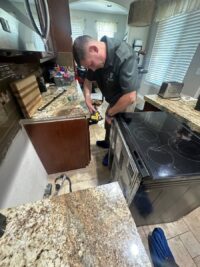 Technician inspecting a glass cooktop surface