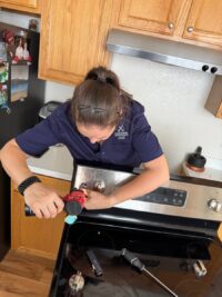 Technician testing range controls during a service call