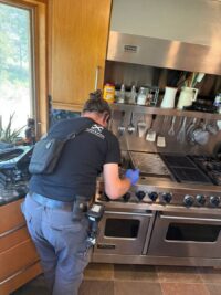 Technician working on a luxury stainless range