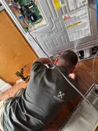 Control board removed for testing during refrigerator repair in Denver