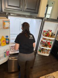 Technician inspecting the fresh food section of a French door refrigerator
