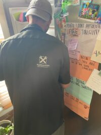 Technician going over refrigerator repair findings with a homeowner in Denver Metro