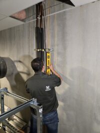 Technician levelling a walk-in panel during a repair