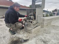 Technician servicing an outdoor condensing unit for a walk-in