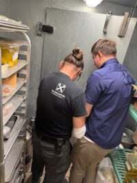 Technician explaining a walk-in repair to the customer