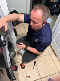Drain hose and tools laid out during a washer drainage repair