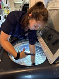 Technician servicing the wash plate of a top load washer