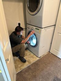 Technician checking the wash drum of a front load washer