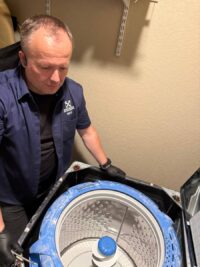 Washer drum removed to replace worn bearings in Denver Metro
